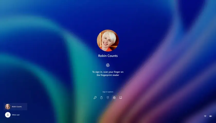 Ekran logowania Windows Hello z uśmiechniętą Robin Counts. Zeskanuj palec, by się zalogować.