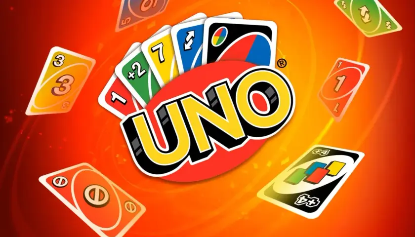 Karty UNO, w tym specjalne karty jak +2 i dzikie karty, unoszą się na pomarańczowym tle.