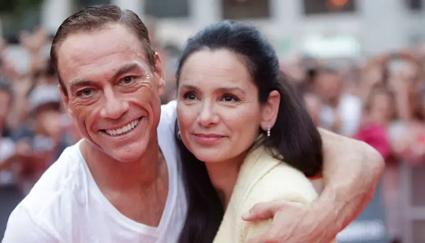 Jean-Claude Van Damme z żoną, uśmiechnięci, w tłumie.