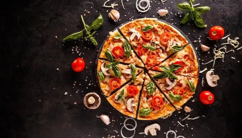 Apetyczna pizza z pomidorami i bazylią. Czy pizza jest zdrowa? Zależy od składników!