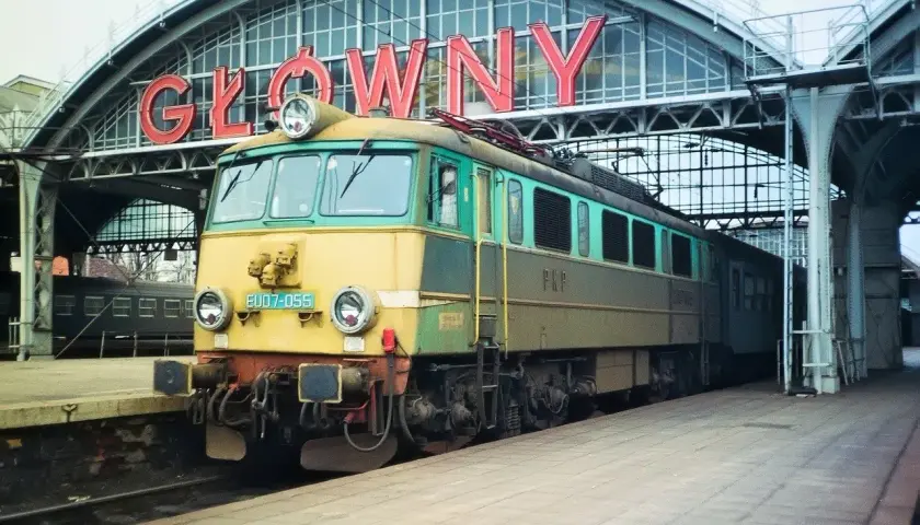 Lokomotywa EP07 na tle napisu "GŁÓWNY". Klasyk PKP gotowy do podróży.