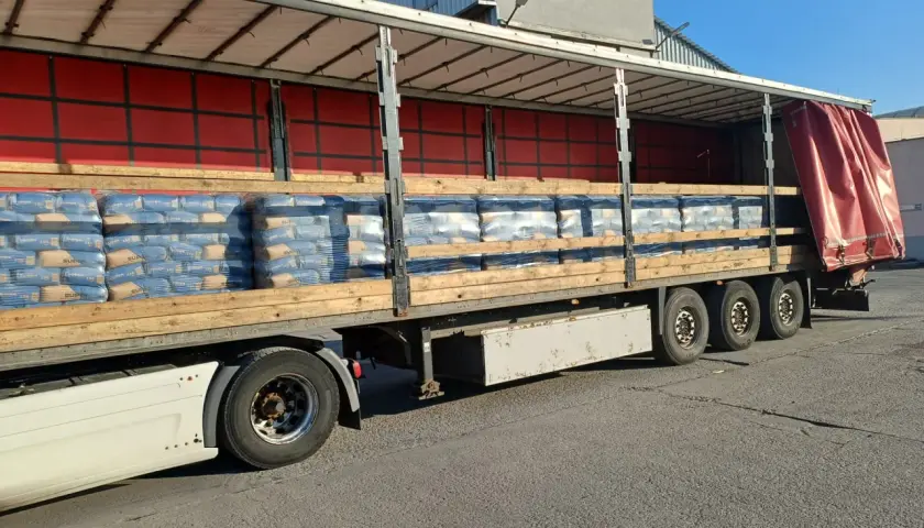 Na palecie ciężarówki ułożono worki z cementem. Widać ich sporo, gotowych do transportu.