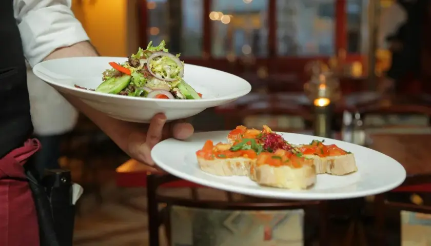 Lekki poczęstunek po pogrzebie: świeża sałatka i bruschetta z pomidorami.