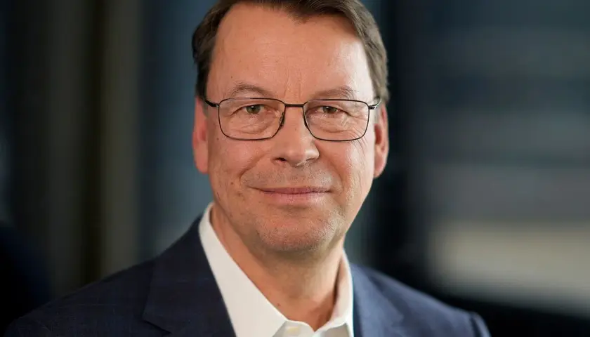 Porträt eines Mannes mit Brille im Anzug. Er könnte ein wichtiger Manager sein, der die Entwicklung der SUSS Microtec Aktie beeinflusst.