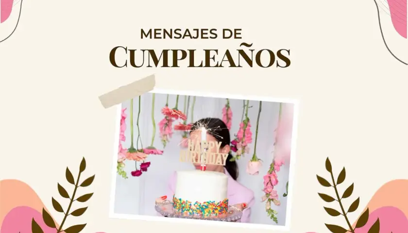 Un pastel blanco con chispas de colores y un letrero "Happy Birthday" adornado con flores colgantes. Ideal para encontrar frases de feliz cumpleaños.