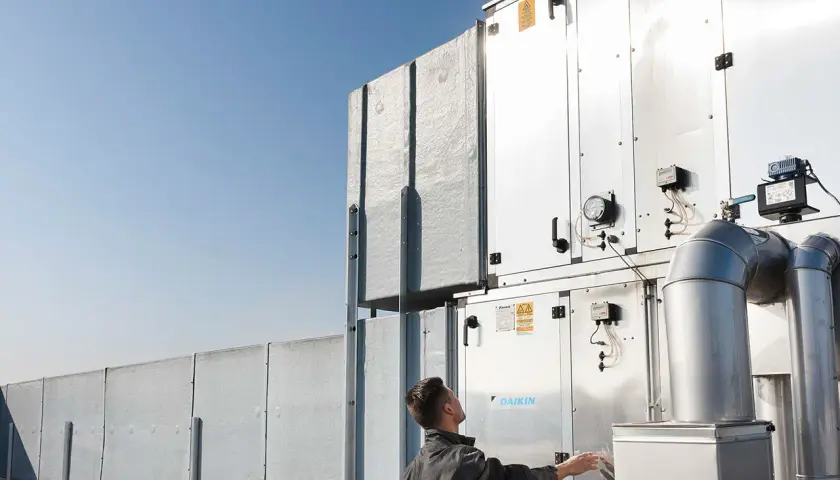 Technik sprawdza instalację wentylacyjną Daikin na dachu. Profesjonalny serwis Daikin Warszawa.