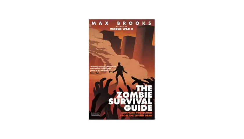 Okładka książki Maxa Brooksa "The Zombie Survival Guide". Człowiek z toporem walczy z hordą zombie. To jedna z tych książek o zombie, które musisz mieć.