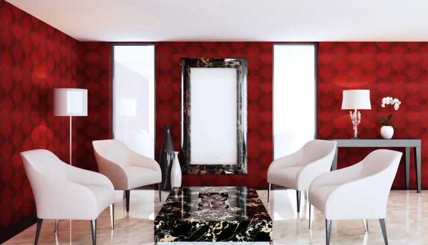 Elegancki salon z tapetą w ciemny czerwony kolor, białymi fotelami i marmurowym stolikiem.