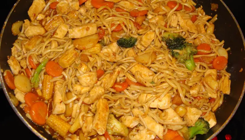 En smakrik kycklingwok med nudlar, morötter, broccoli och majskolvar i en härlig sås.