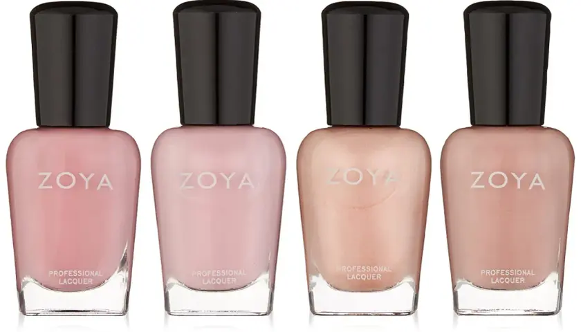 Fyra flaskor zoya nagellack i nyanser av rosa och beige.