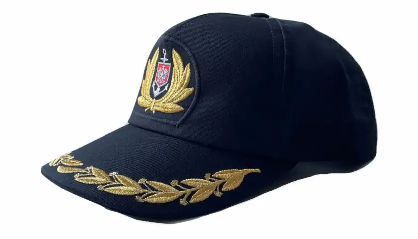 Granatowa czapka z wyszywanym godłem i złotym wieńcem laurowym. Elegancki cap, idealny na specjalne okazje.