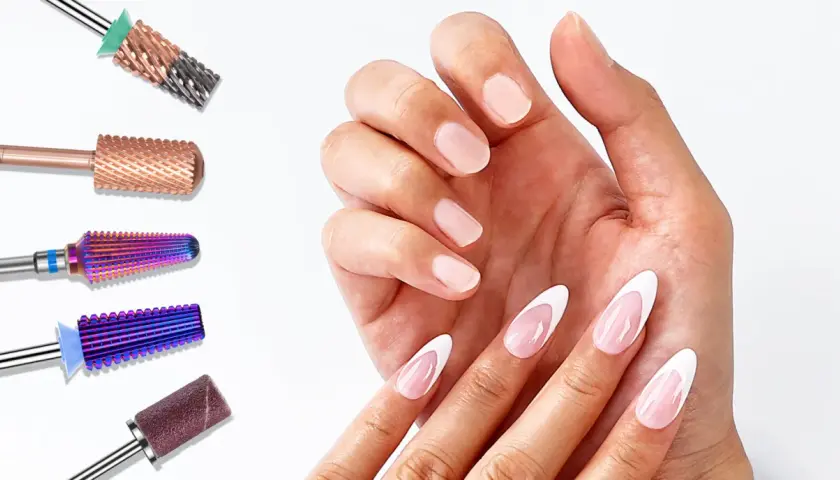 Różne frezy do paznokci, w tym idealny frez do ściągania żelu, obok dłoni z eleganckim french manicure.