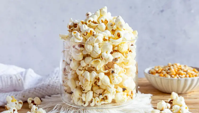 Ein Glas voller frisch gemachtem Popcorn, perfekt für einen Filmabend. So einfach ist Popcorn selber machen!