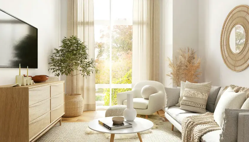 Salon cosy et chic avec canapé, fauteuil, table basse, commode en bois, plante verte et miroir rond en rotin. Parfait pour une deco salon cocooning chic.