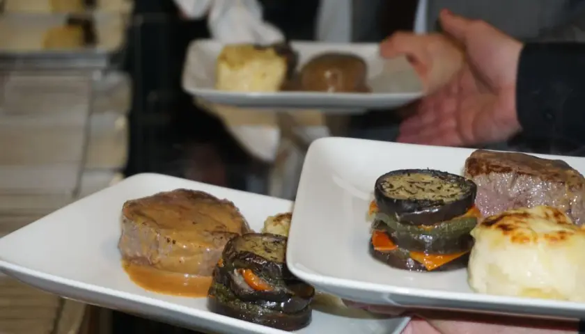 Un délicieux repas chaud de mariage avec des médaillons de bœuf, des légumes grillés et une purée gratinée.