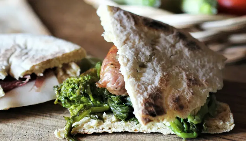 Torta al testo ripiena di salsiccia e verdure, un sapore autentico.