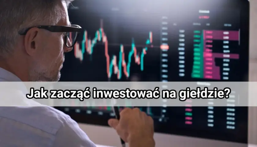Mężczyzna w okularach patrzy na wykresy giełdowe na monitorze.