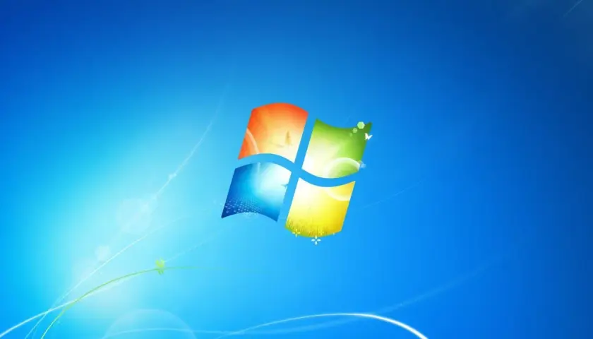 Ikona systemu Windows 7 na niebieskim tle z delikatnymi, świetlistymi liniami i motylami.