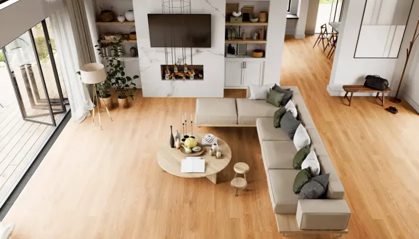Soggiorno moderno con divano angolare, tavolino rotondo e camino. Il calore del legno dei pavimenti LVT crea un'atmosfera accogliente.