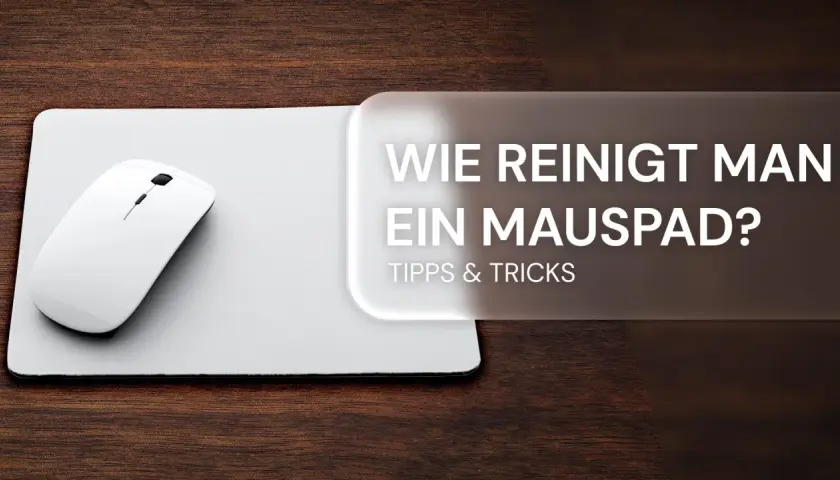 Weiße Maus auf weißem Mauspad, daneben Text: "Wie reinigt man ein Mauspad? Tipps & Tricks".