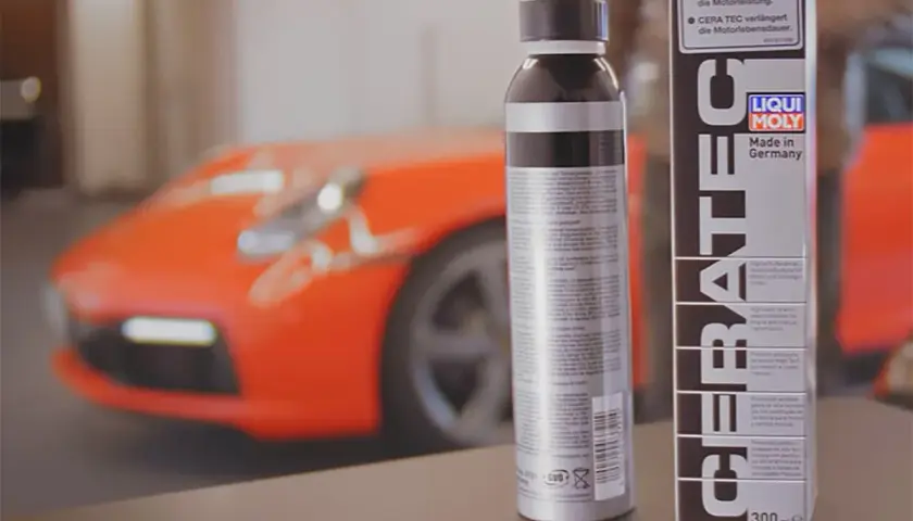 Dwa opakowania LIQUI MOLY CERA TEC obok pomarańczowego samochodu sportowego. Produkt zapewnia optymalną moc i dłuższą żywotność silnika.
