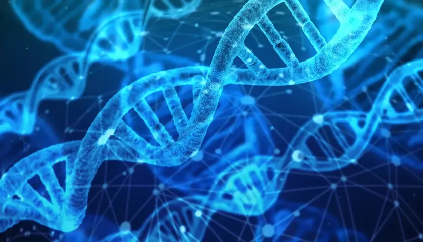 Błękitne, świetliste helisy DNA, symbolizujące postęp w nauce i scjentyzm, unoszą się w cyfrowej przestrzeni.