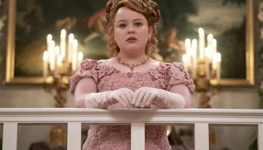 Penelope Featherington w różowej sukni z kwiatowymi zdobieniami, przygotowuje się na bal w Bridgertonowie sezon 3.