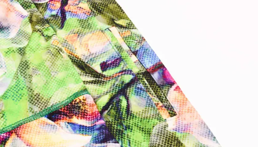Close-up of a pocket on colorful floral leggings, showing how to add pockets to leggings with neat stitching.