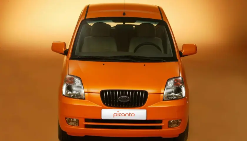 Vista frontale di una Kia Picanto arancione. Nonostante il suo aspetto allegro, alcuni proprietari segnalano **kia picanto difetti** comuni.