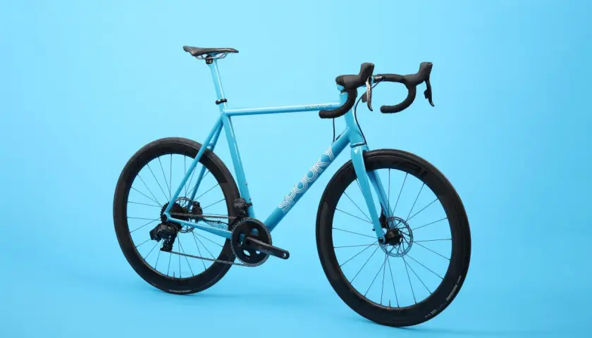 A bright blue road bike with black wheels and handlebars. The word "SPOOKY" is visible on the frame, hinting at these spooky bikes.