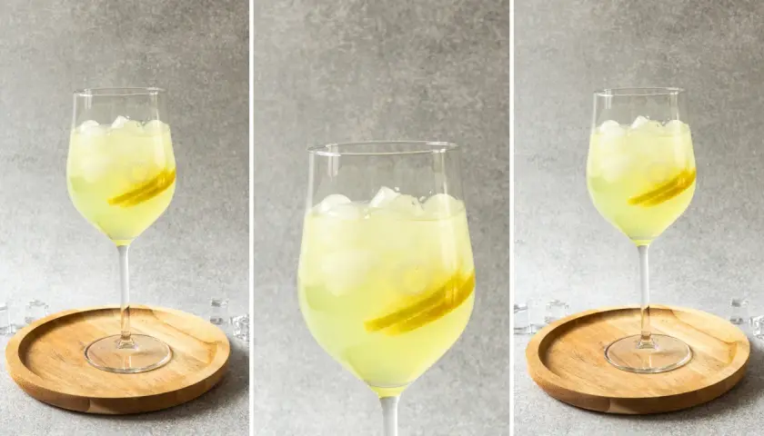 Orzeźwiający limoncello spritz przepis: jasny, cytrynowy drink z lodem i plasterkami cytryny w kieliszku.
