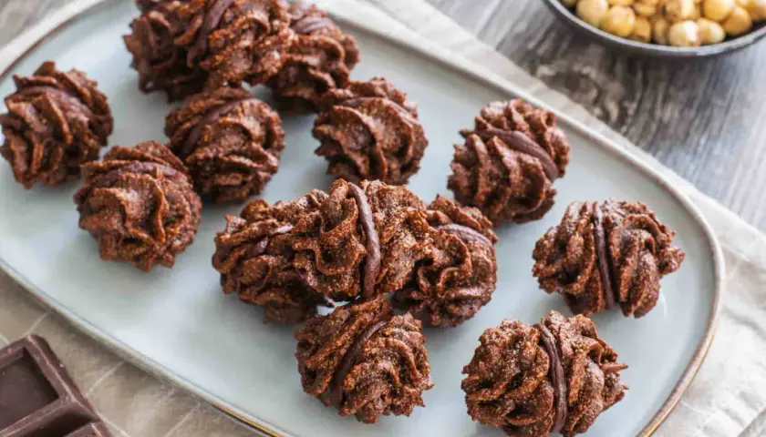 Deliziosi baci di Alassio al cioccolato, con la loro forma irregolare e il ripieno goloso, pronti per essere gustati.