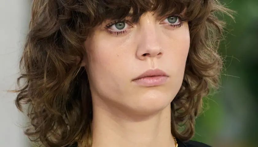 Modelka prezentuje modne fryzury półdługie z grzywką cieniowane, podkreślające jej naturalne piękno.
