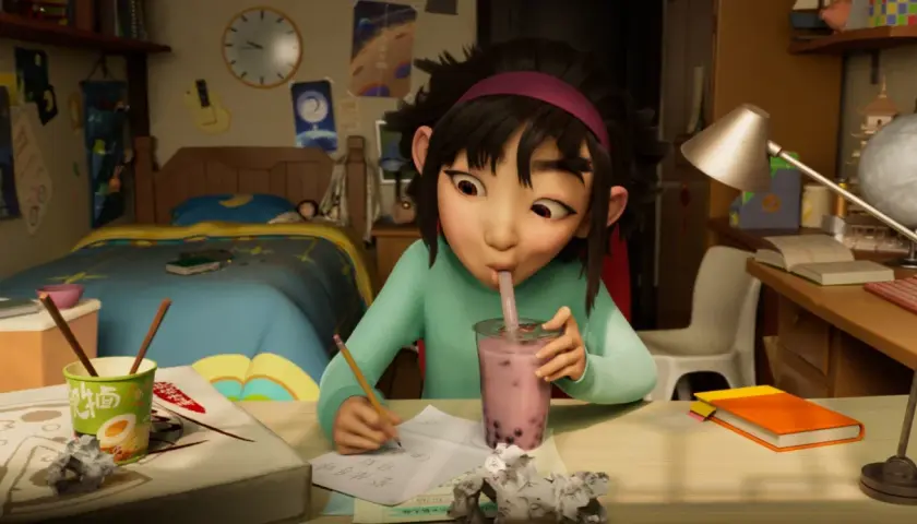 Dziewczynka pije bubble tea, pisząc wypracowanie. Może to jedna z bajek na Netflixie, która inspiruje do nauki i marzeń.