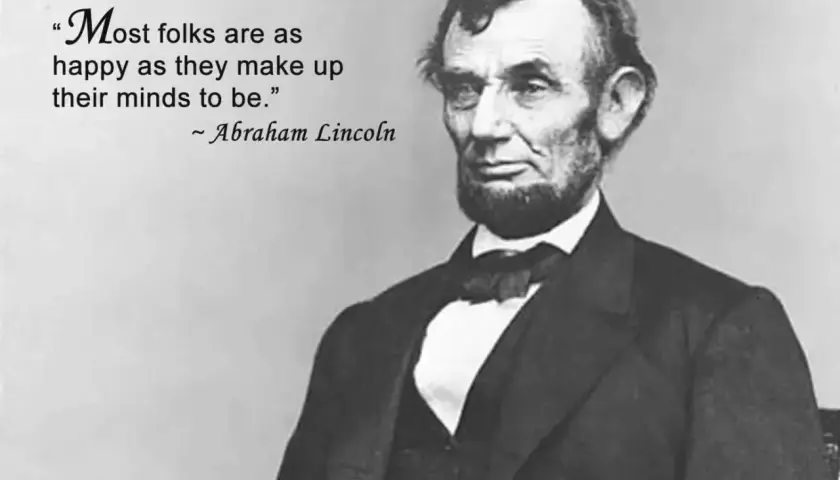 Ritratto di Abraham Lincoln con la citazione "Most folks are as happy as they make up their minds to be." - frasi sull'arte in inglese.
