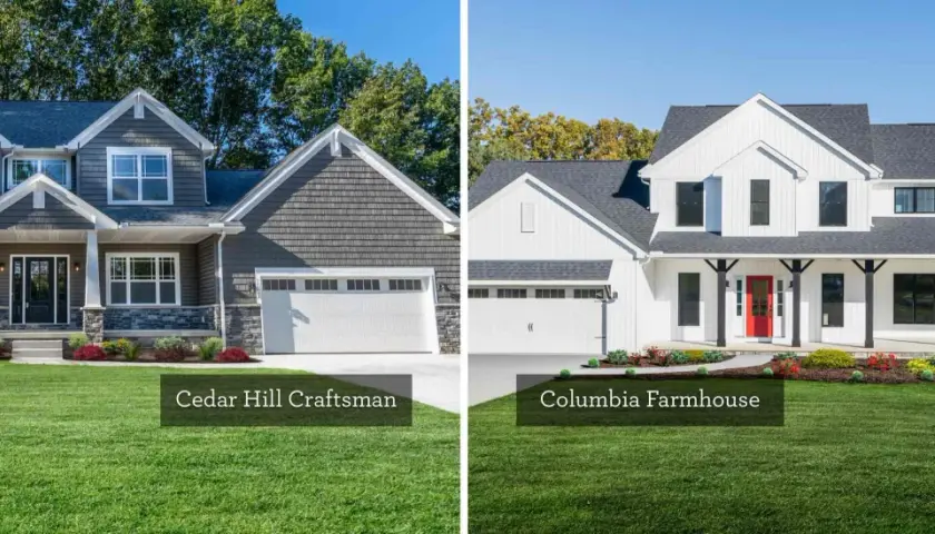 A dark gray craftsman house with stone accents stands next to a bright white modern farmhouse with a red door.