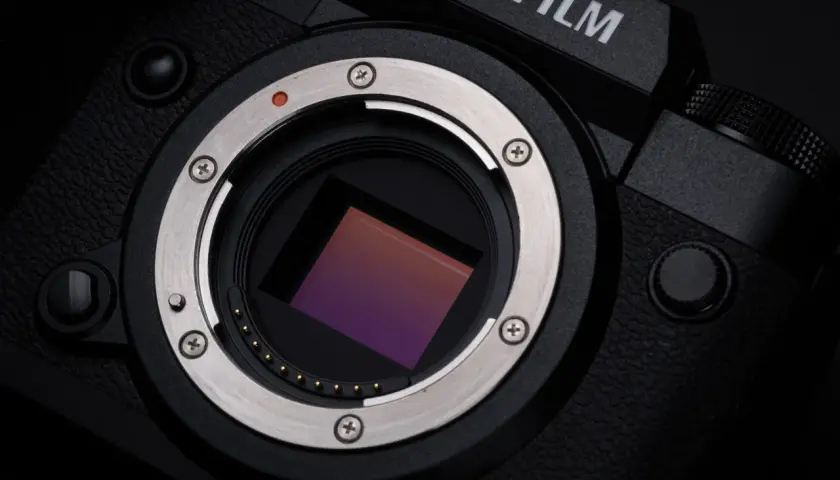 Zbliżenie na sensor aparatu Fujifilm XH2S. Widoczny metalowy pierścień mocowania obiektywu i złote styki.