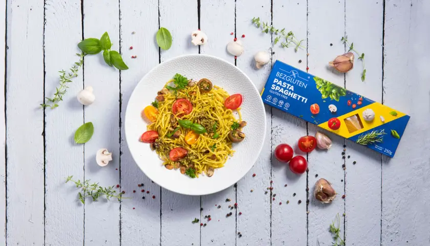 Pyszne spaghetti bezglutenowe z pomidorkami i pesto, idealne dla restauracji szukających opcji dla alergików.