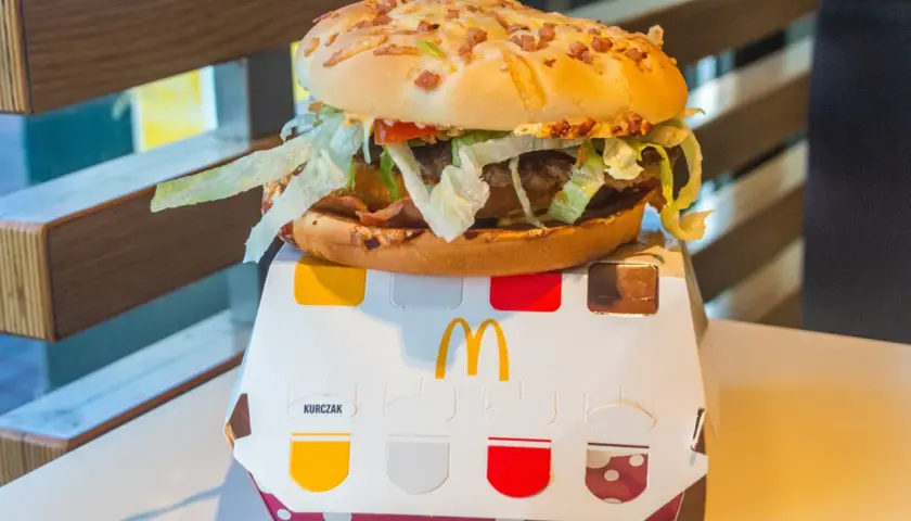 Pyszny burger drwala z chrupiącym bekonem i świeżą sałatą, idealny na szybki posiłek.