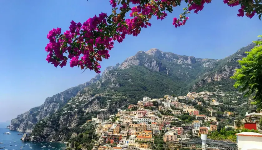 A stunning view of Positano, a colorful cliffside village on the Amalfi Coast, perfect after your trip from Naples airport.