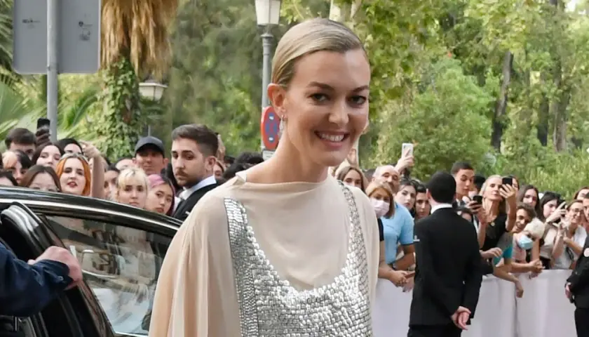 Marta Ortega Pérez sonríe a la multitud mientras llega a un evento, rodeada de fans con móviles.