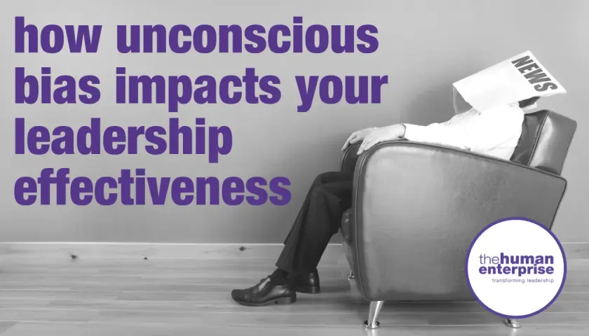 A man sits with a newspaper over his head, symbolizing how unconscious bias coaching can improve leadership effectiveness.