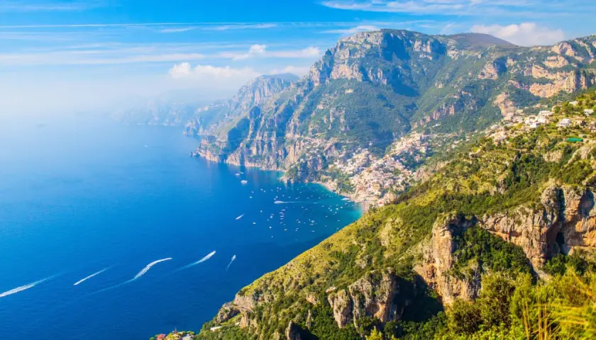 A stunning view of the Amalfi Coast, where the Path of the Gods winds through dramatic cliffs overlooking the azure sea.