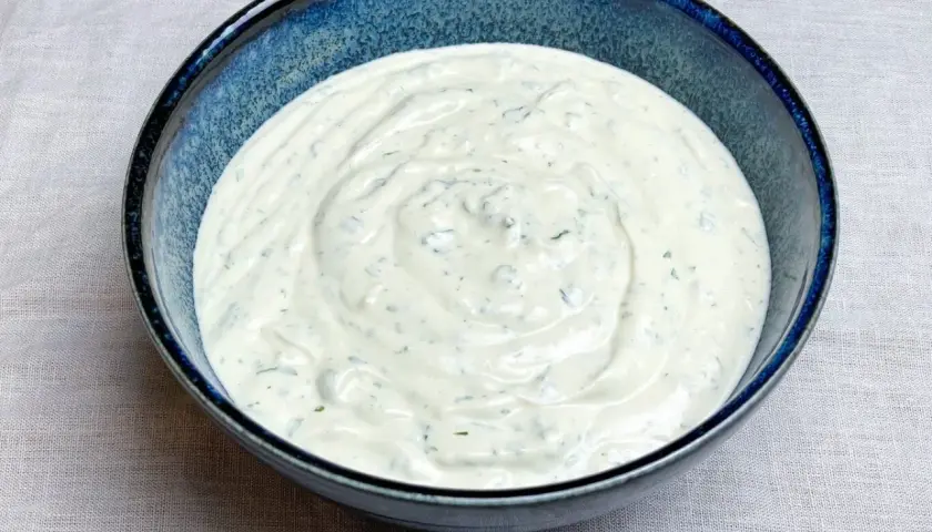 En krämig sås på grekisk yoghurt med örter, perfekt som tillbehör till kyckling.