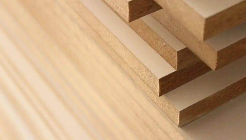 Stack of solid mdf boards, showing their layered construction and fine texture.