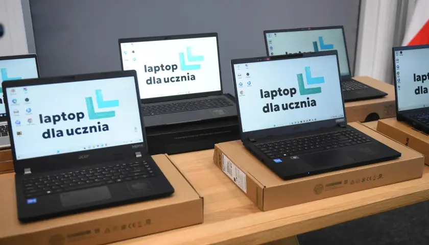 Laptopy dla uczniów, które od 2026 roku mają być tańsze i gorszej jakości, stoją na drewnianym stole.