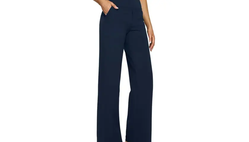 A person models navy blue yoga pants with a wide leg, perfect for hemming to achieve the ideal length for any activity.