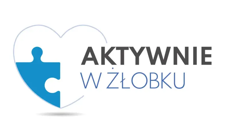 Niebieski element puzzla w kształcie serca z napisem "AKTYWNIE W ŻŁOBKU". Dofinansowanie do żłobka ułatwia rodzicom powrót do pracy.