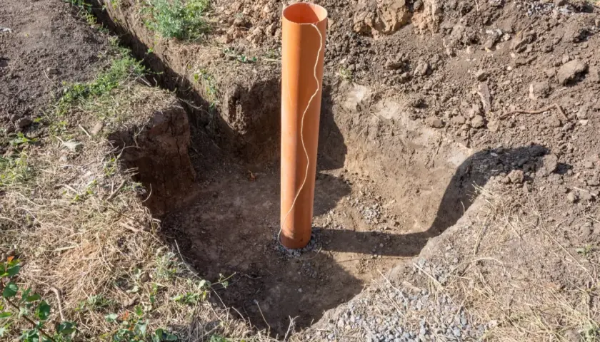 Scavo per pozzo con tubo arancione. Un passo fondamentale per capire come trovare l'acqua per fare un pozzo.