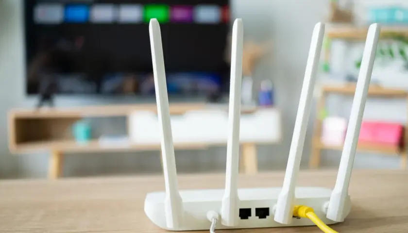 Router z antenkami, kluczowy element instalacji internetowej w domu. Zapewnia łączność dla telewizora i innych urządzeń.